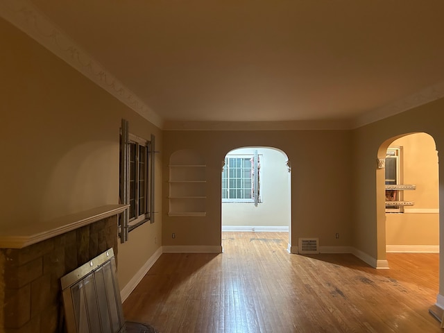 unfurnished room with wood-type flooring and ornamental molding