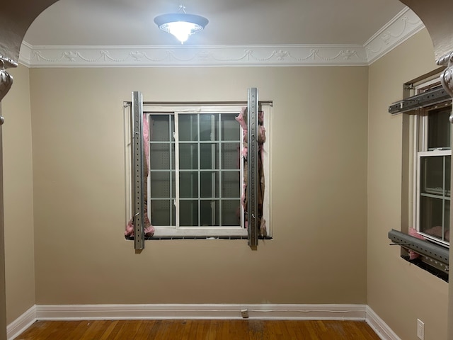 unfurnished room with wood-type flooring and ornamental molding