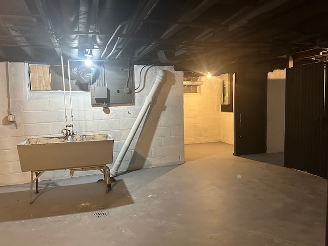 basement with sink and electric panel