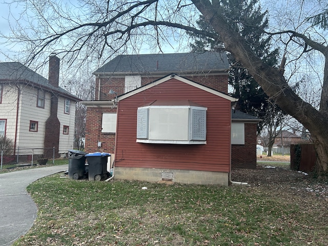 view of side of home with a lawn