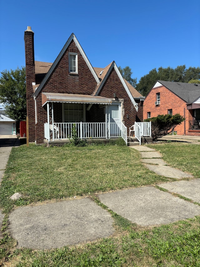 bungalow-style home with a porch and a front lawn