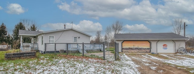 view of snowy exterior with a deck and a garage