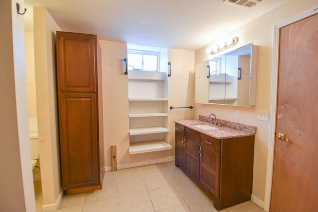 bathroom with tile patterned floors, vanity, and toilet