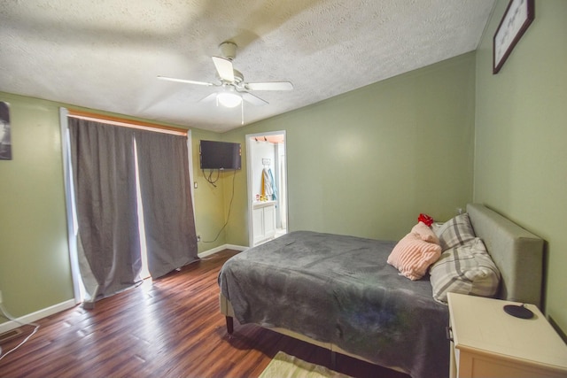 bedroom featuring a textured ceiling, ceiling fan, and dark wood-type flooring