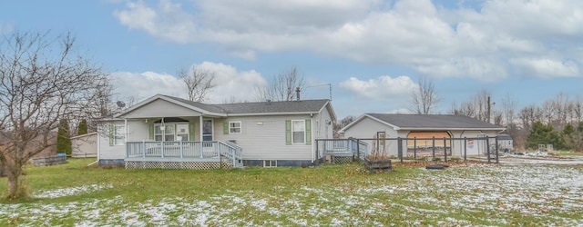 rear view of property with a lawn, a porch, and a garage