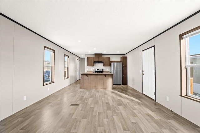 unfurnished living room with light wood-type flooring and crown molding