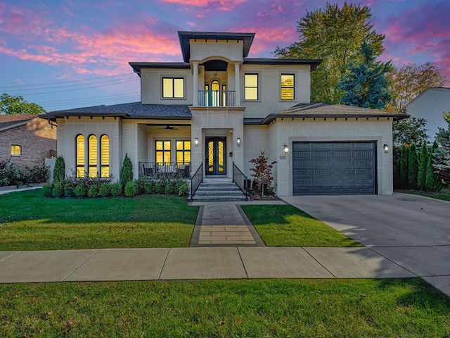 view of front facade featuring a lawn, a porch, a garage, and french doors