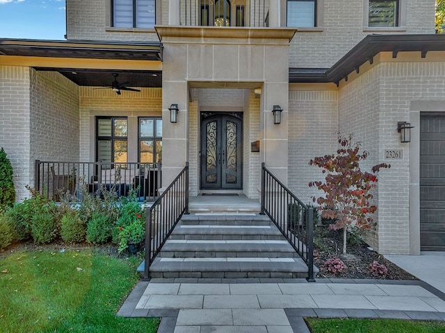 doorway to property featuring ceiling fan and a porch