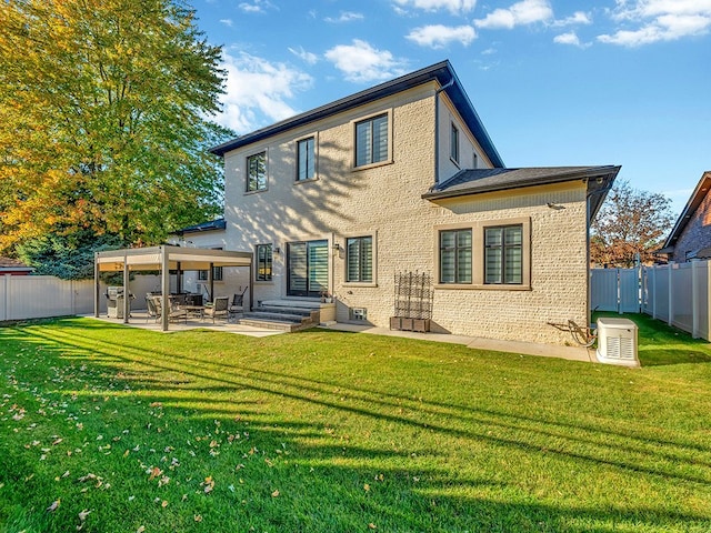 rear view of property featuring a lawn and a patio