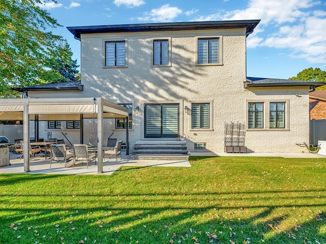 back of house featuring a lawn and a patio area