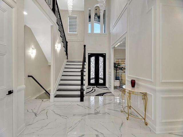 foyer with a high ceiling and an inviting chandelier