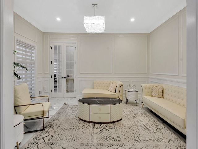 living room featuring a chandelier and french doors