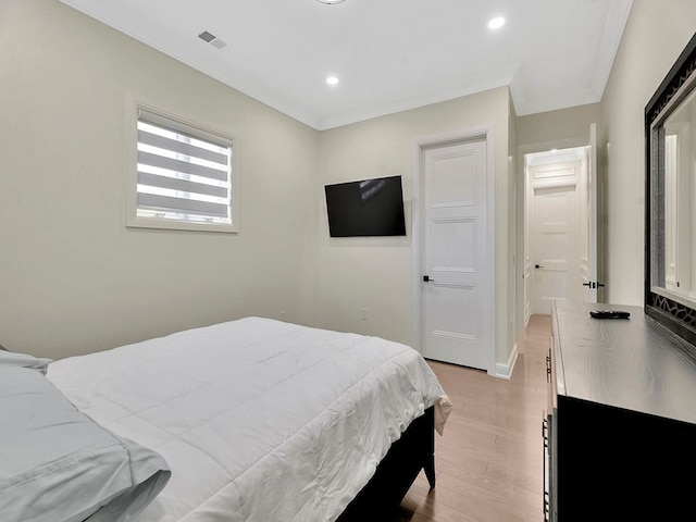 bedroom featuring light hardwood / wood-style floors and ornamental molding