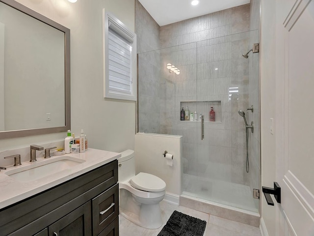 bathroom featuring tile patterned flooring, vanity, an enclosed shower, and toilet