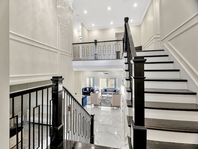 stairway featuring crown molding