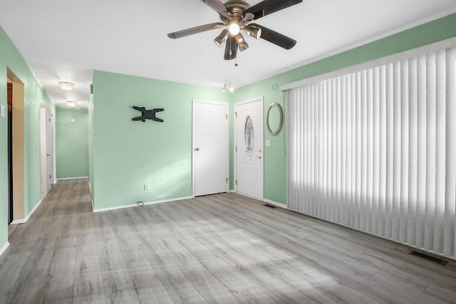 empty room featuring light hardwood / wood-style flooring and ceiling fan