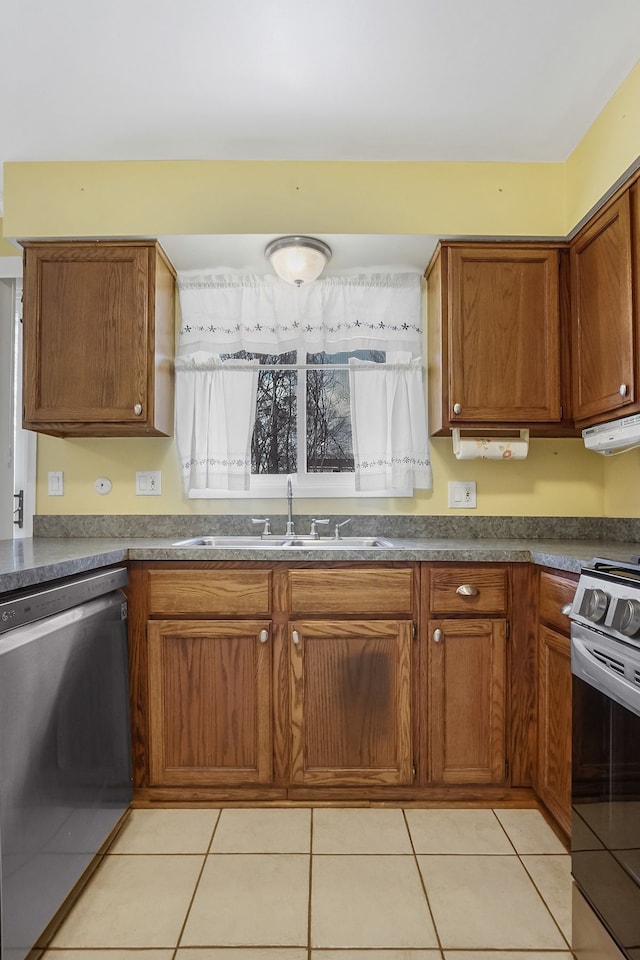 kitchen with sink, light tile patterned floors, and appliances with stainless steel finishes