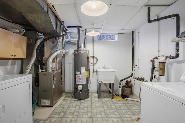 utilities featuring washer and clothes dryer, sink, and water heater