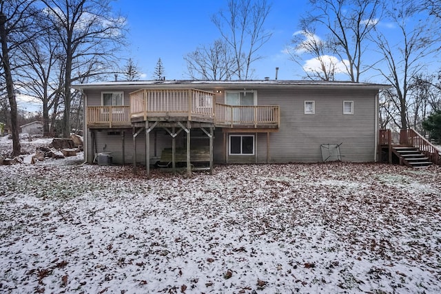 snow covered house featuring a deck and central air condition unit