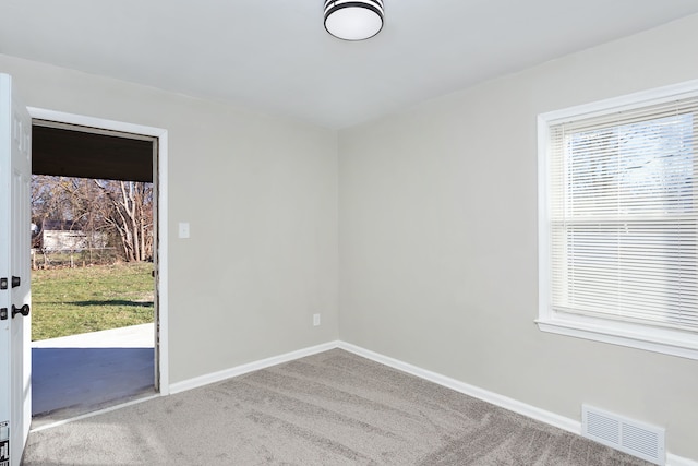 carpeted empty room with plenty of natural light