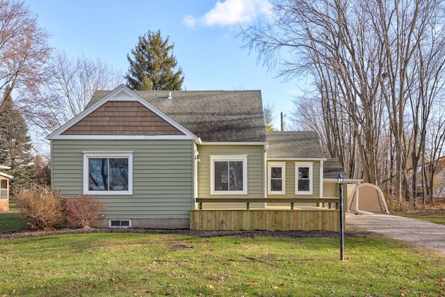 view of home's exterior with a garage and a yard