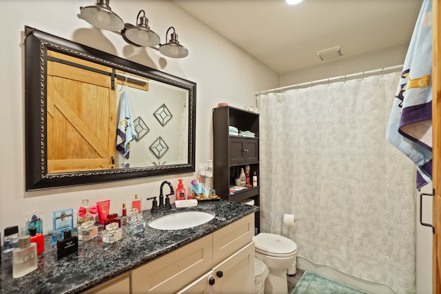 bathroom with a shower with curtain, vanity, and toilet