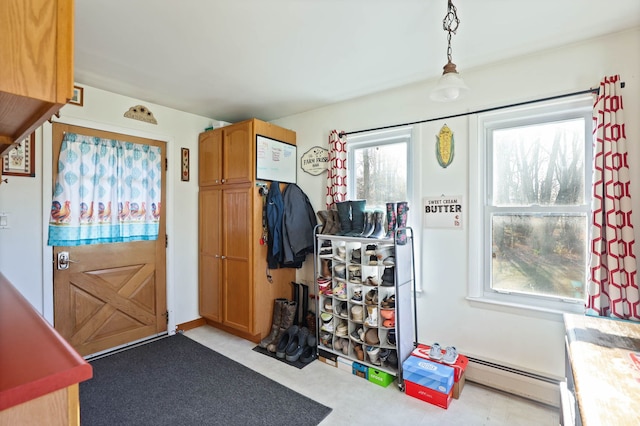 interior space featuring light carpet and a baseboard heating unit