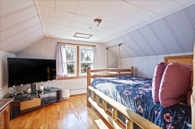 bedroom featuring vaulted ceiling and light hardwood / wood-style flooring