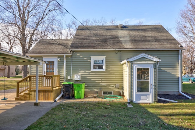 rear view of property with a lawn