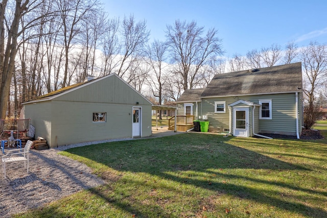 rear view of property featuring a yard