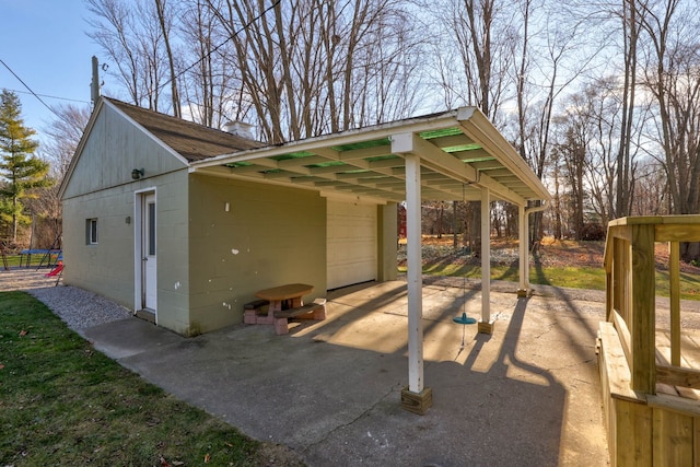 view of outbuilding featuring a garage and a carport