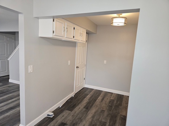 clothes washing area with dark hardwood / wood-style flooring