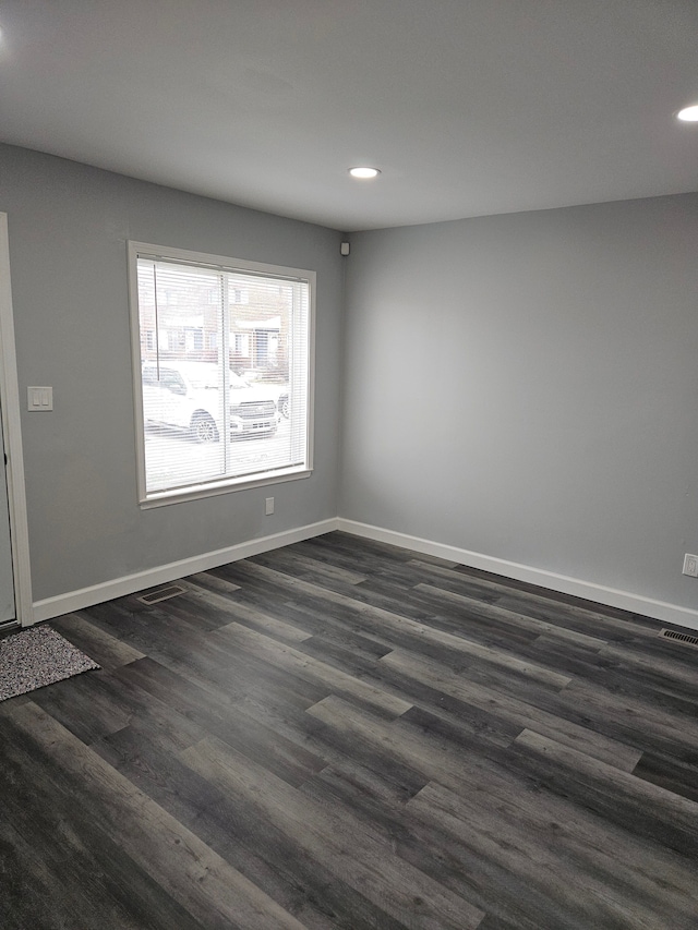 spare room featuring dark hardwood / wood-style floors