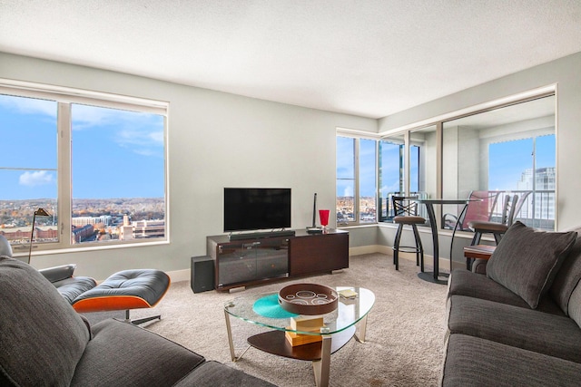 living room featuring a textured ceiling, carpet floors, and plenty of natural light