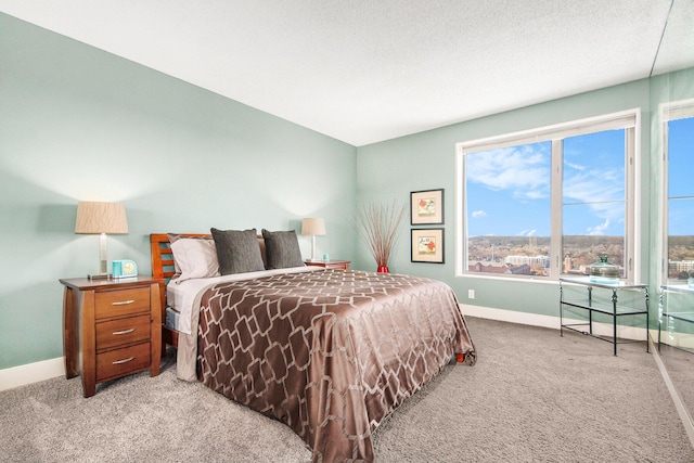 bedroom featuring light colored carpet and a textured ceiling