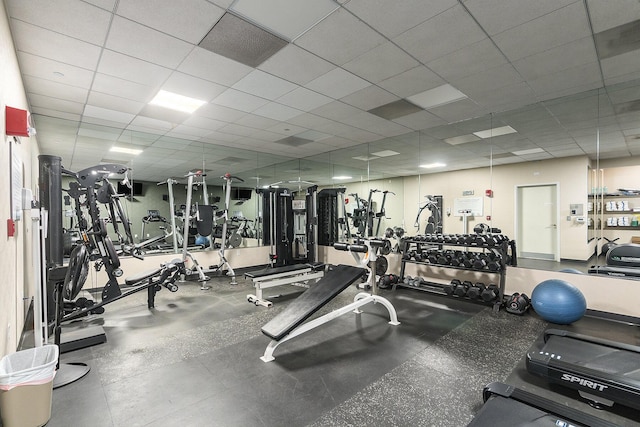 gym with a paneled ceiling