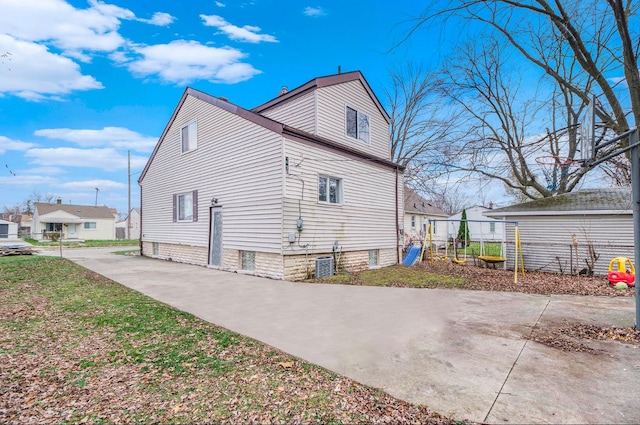 view of home's exterior featuring central AC unit and a playground