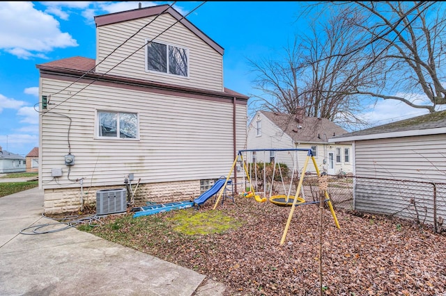 view of property exterior with a patio, a playground, and cooling unit