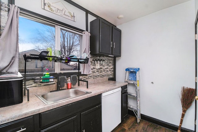 kitchen featuring dishwasher, dark hardwood / wood-style flooring, decorative backsplash, and sink