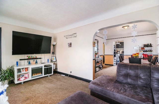 carpeted living room featuring a textured ceiling