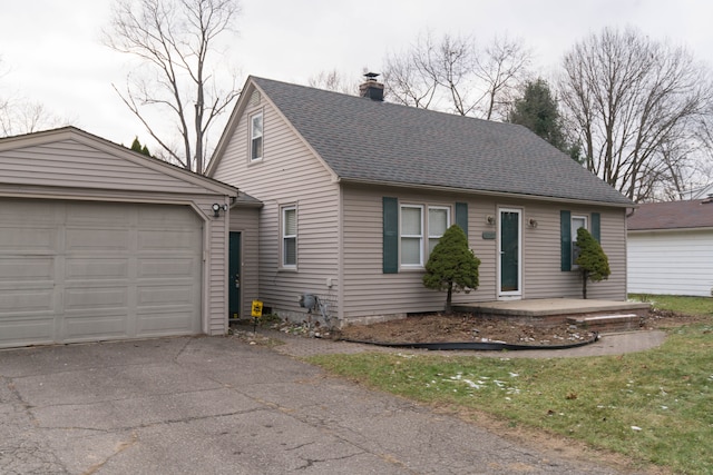 view of front facade featuring a garage and an outbuilding