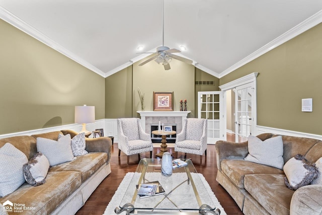 living room featuring a fireplace, ornamental molding, dark wood-type flooring, and vaulted ceiling