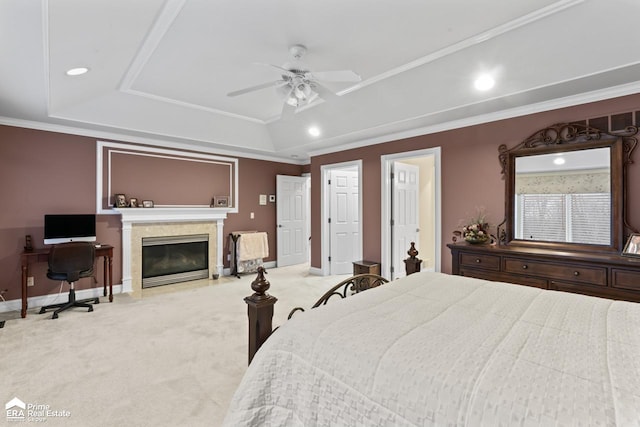 carpeted bedroom featuring a tray ceiling, ceiling fan, and crown molding