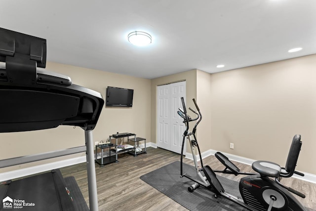 workout area featuring dark wood-type flooring