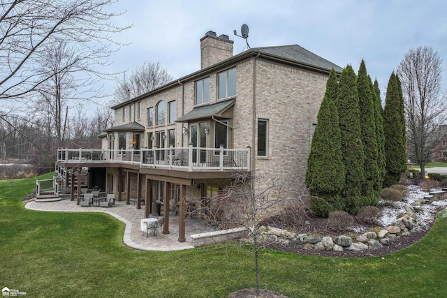 back of property featuring a yard, a deck, and a patio area