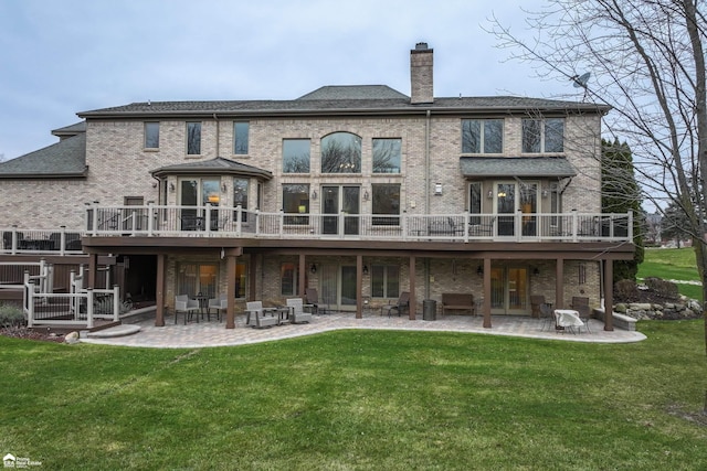 rear view of house with a yard, a patio, and a deck