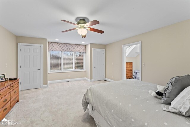 bedroom featuring light carpet and ceiling fan