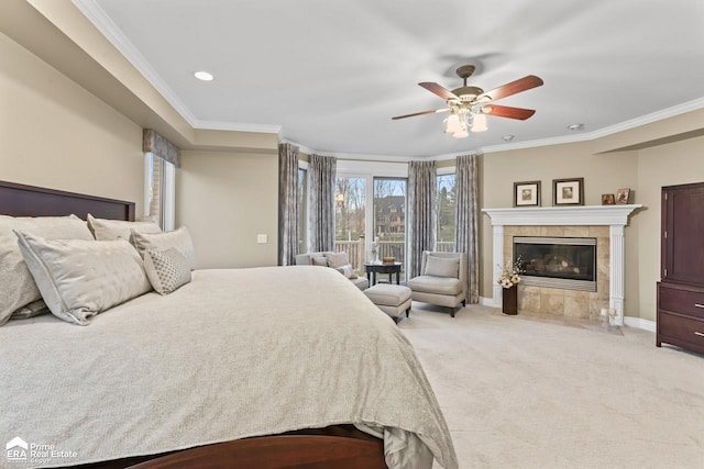 bedroom with ceiling fan, light colored carpet, ornamental molding, and a tile fireplace