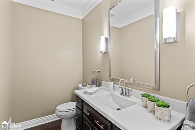 bathroom featuring hardwood / wood-style floors, vanity, toilet, and crown molding