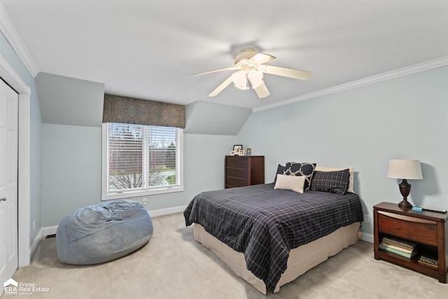 carpeted bedroom featuring ceiling fan, ornamental molding, and a closet